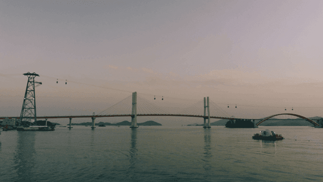 Cable car and bridge over calm sea