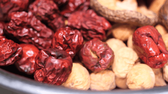 Bowl containing dried dates and nuts
