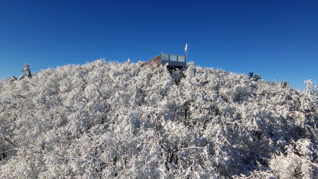 Observation deck on top of a white snow-covered mountain and magnificent view