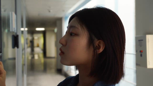 Woman looking in from the hallway