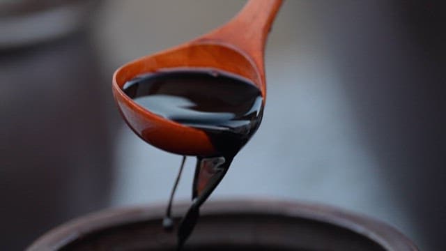 Streaming Soy Sauce Pouring from Wooden Ladle