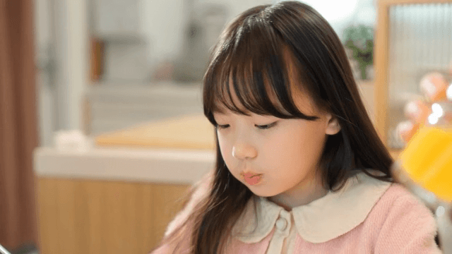 Child enjoying a meal indoors