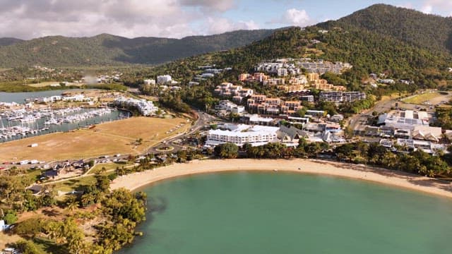 Coastal view with resort, mountains and beach