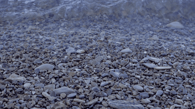 Waves gently crashing on a pebble beach