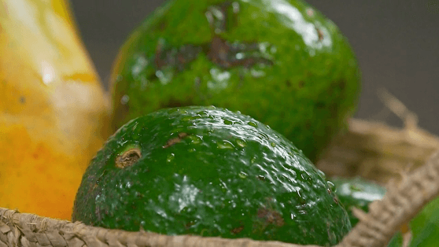 Fresh avocados in a woven basket