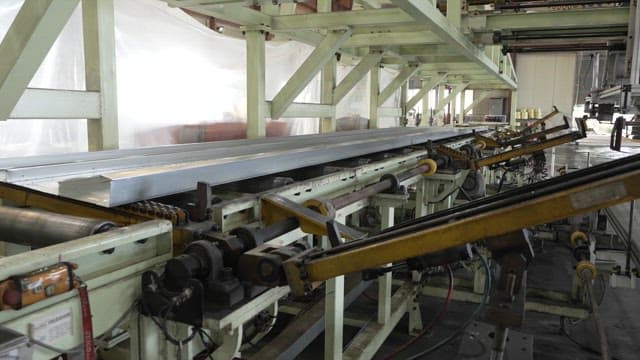 Metal sheets being processed in a factory