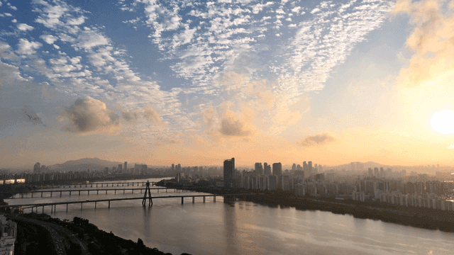 River and skyline of city at sunrise
