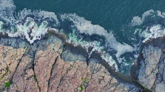 Waves crashing on rocky shoreline