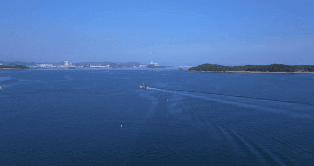 Ship sailing on vast blue sea