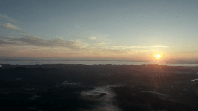 Sunset over a vast landscape with mountains
