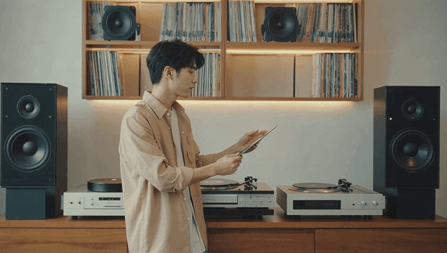 다양한 스피커와 레코드판을 고르는 남성