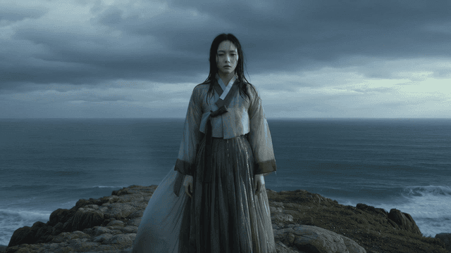 Woman wearing soaking wet Hanbok by sea