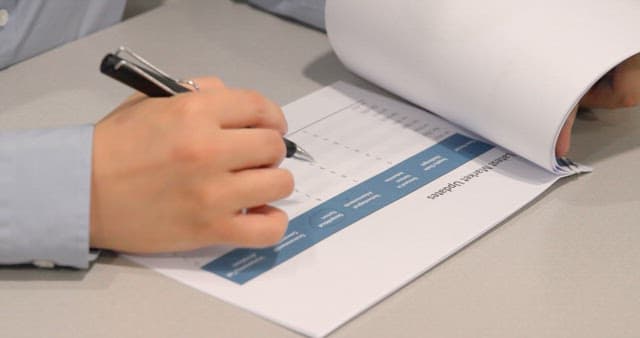 Office Worker Analyzing Statistical Data in Documents