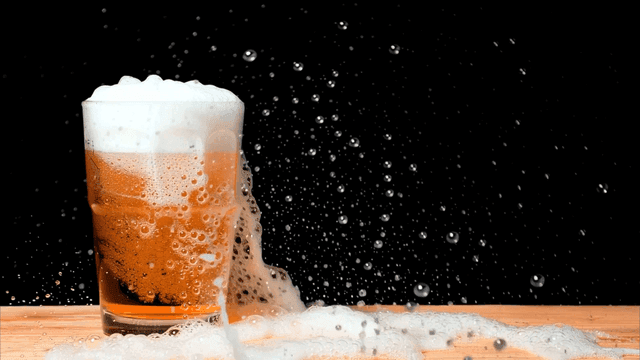 테이블 위에 거품이 넘치는 맥주
