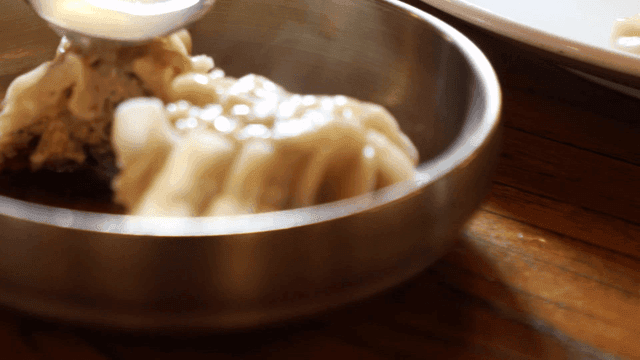 Broth poured over steamed dumplings