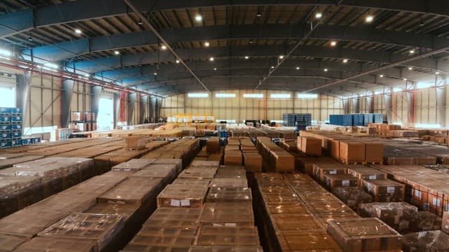 Large warehouse with numerous boxes neatly stacked