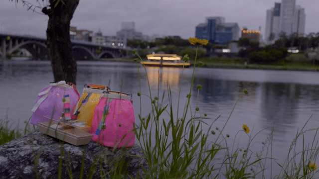 Lanterns by the riverside at dusk