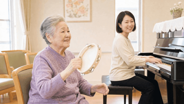 Elderly woman playing tambourine with joy