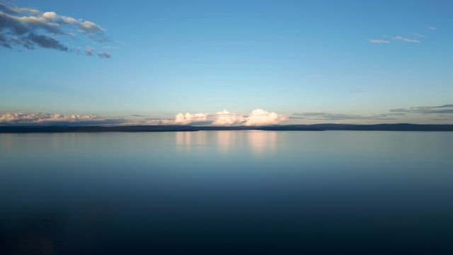 Calm lake with distant clouds