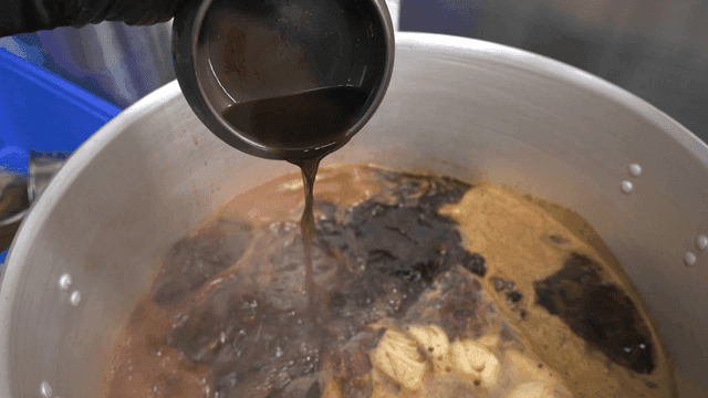 Soy sauce broth poured into boiling pot