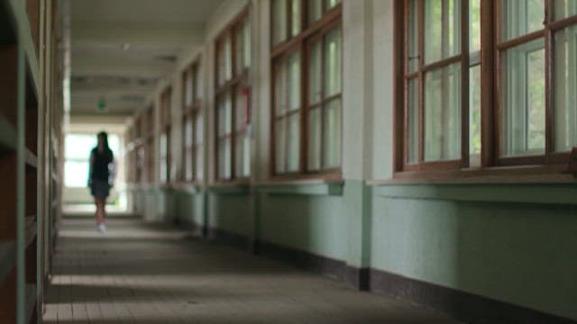 Silhouette of Student Walking in Hallway