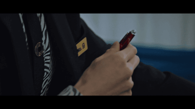 Person taking out red pen from his jacket pocket