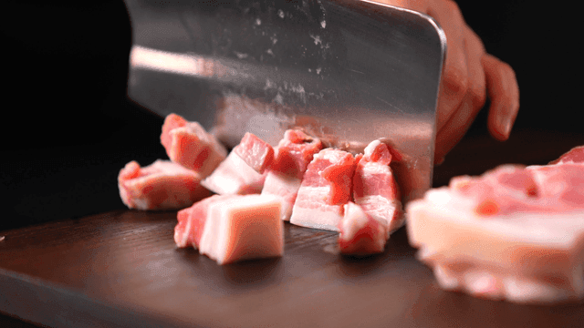 Diced pork on cutting board