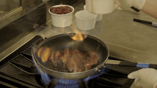 Scene of pouring wine into heated pan