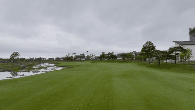 A golf course with surrounding buildings
