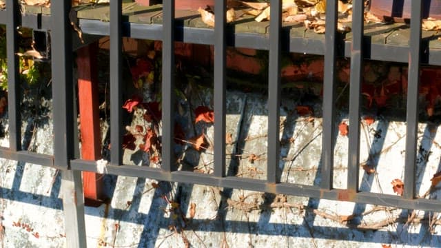 Close-up of a railing with sunlight and shadows