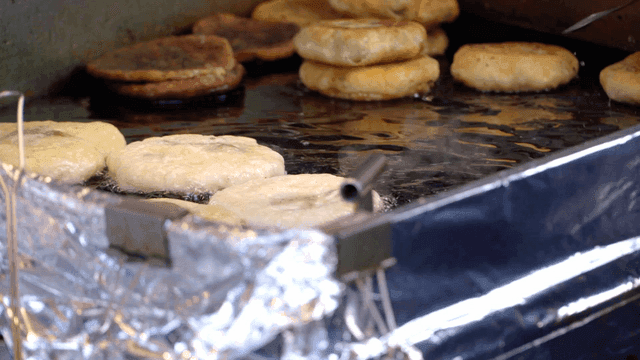 Crispy hotteok being cooked on iron plate