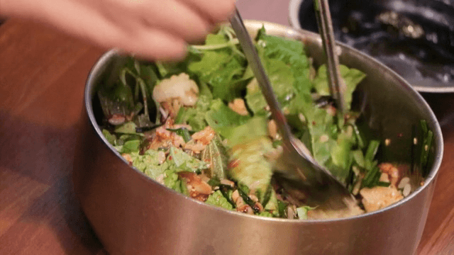 Mixing fresh vegetables and rice in a bowl