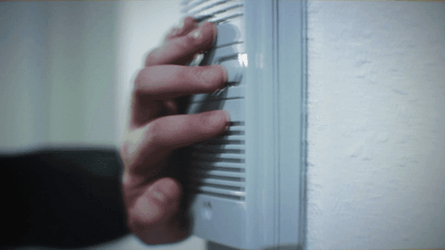 Hand pressing doorbell