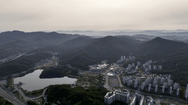 A city nestled among green mountains
