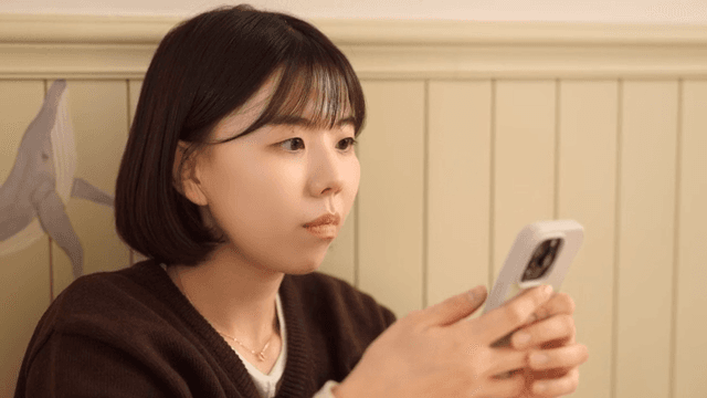 Young woman using smartphone in room