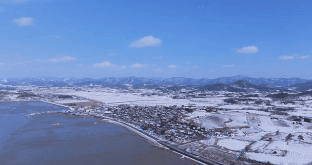 Snow-covered Hanok village and fields