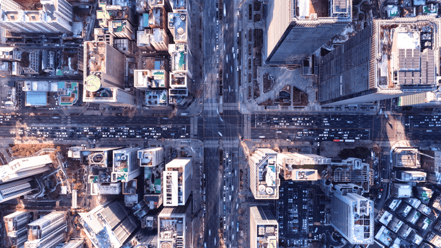 Bustling city intersection viewed from above.