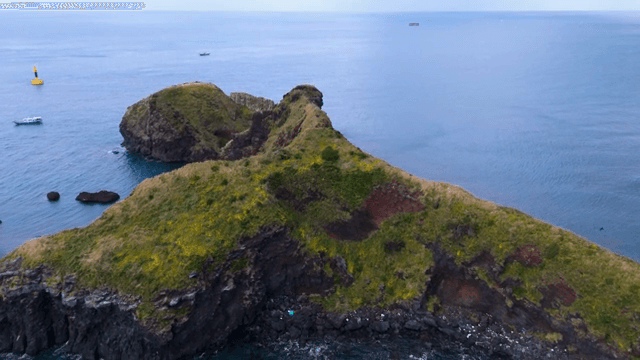 Small island surrounded by blue sea