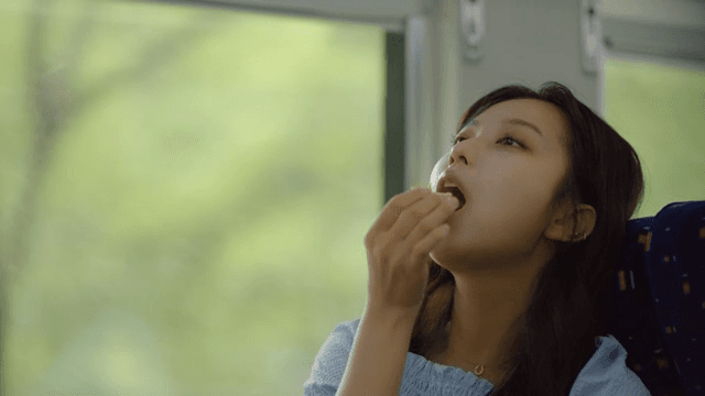 Woman eating eggs on a train