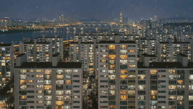 Apartment complex with lights on on snowy night