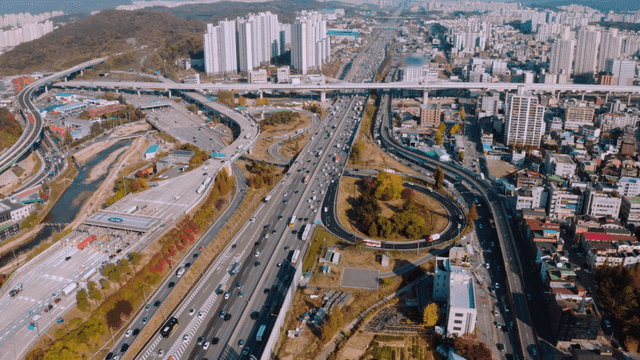 A bustling city highway with skyscrapers
