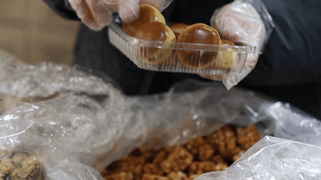 King chestnut bread packaged by hands wearing plastic gloves