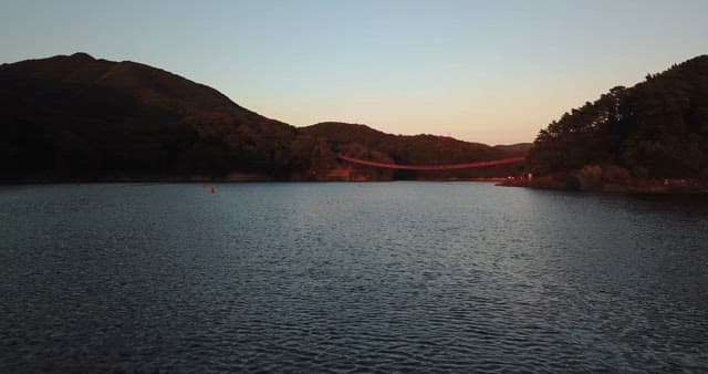 Serene lake with a distant bridge