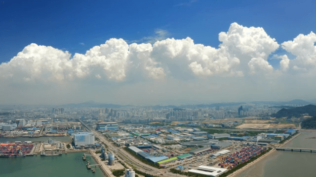 Vast port city landscape under a picturesque sky