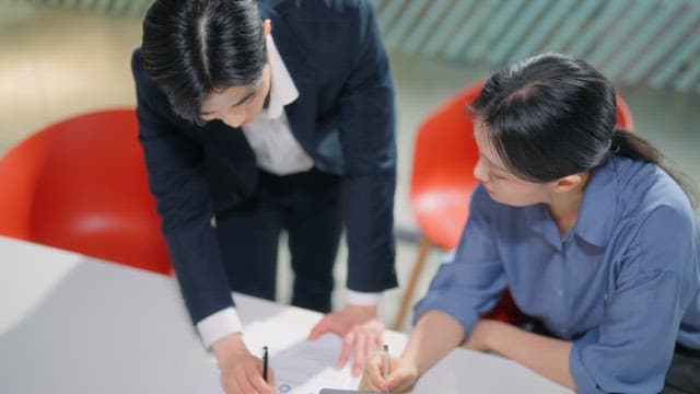 Two colleagues discussing documents