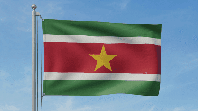Flag of Republic of Suriname fluttering under clear sky