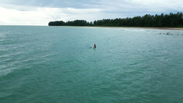 Person surfing on a calm sea