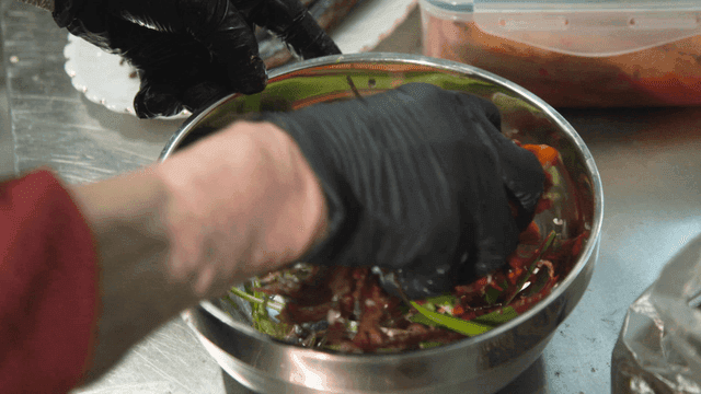 Seasoned Gwamegi mixing with sauce in bowl