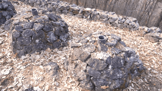 Pile of stones surrounded by autumn leaves