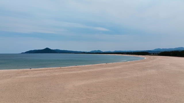 Serene beach with distant mountains